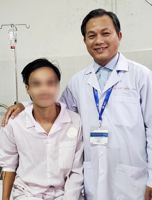 Nam thanh niên (trái) sau khi phẫu thuật và bác sĩ điều trị. Ảnh: Bác sĩ cung cấp.