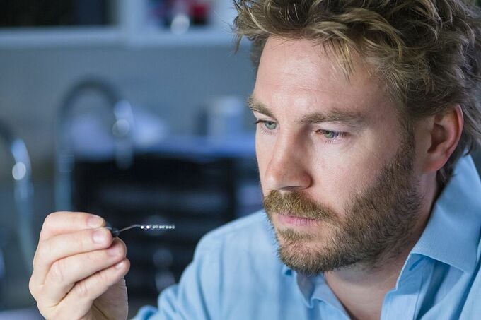 Nicholas Opie, đồng sáng lập công ty Synchron kiêm Giám đốc Công nghệ đang cầm thiết bị cảm biến não Stentrode do công ty sáng chế. Ảnh: WSJ