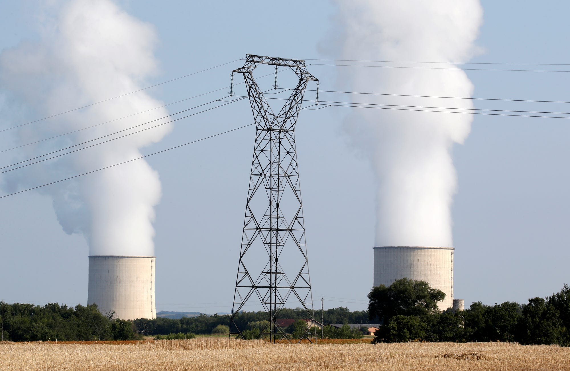 Cooling towers and high-tension electrical power lines are seen near the Golfech nuclear plant in France. Photo by Reuters.