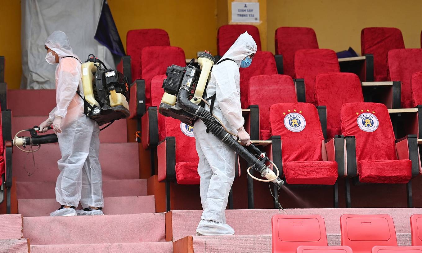 Two staff disinfect Hang Day Stadium in Hanoi, March 2021. Photo by VnExpress/Giang Huy.